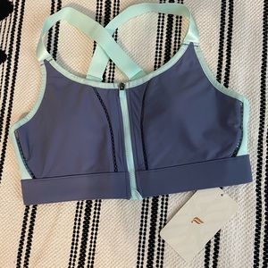 Purple and sea foam Fabletics zip-up sports bra